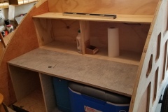 Deciding how high to put this shelf, how deep to make the storage, all difficult decision based on what's being stored. Note the Formica on the counter at this point.