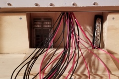 Wiring exiting the fuse compartment.