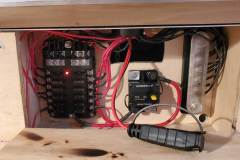 Fuse compartment wired with battery charger